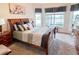 Bright main bedroom boasts large windows with water views, a sled bed, and decorative accents at 446 Davinci Pass, Poinciana, FL 34759