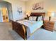 Spacious main bedroom features two bedside tables, artwork, and plush carpeting at 446 Davinci Pass, Poinciana, FL 34759