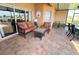 Screened-in patio features beautiful brick floors and comfortable seating, perfect for relaxing outdoors at 446 Davinci Pass, Poinciana, FL 34759