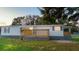 Well-maintained home showcasing a covered front porch with wooden railing, offering a welcoming entrance at 4805 1St Nw St, Lakeland, FL 33810