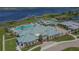 An aerial view of a large clubhouse, a pool, a pier, a bocce ball court and tennis courts at 4911 Drawdy Ct, St Cloud, FL 34772