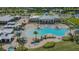 An aerial view of a large community pool with palm trees, lounge chairs, and covered seating at 4911 Drawdy Ct, St Cloud, FL 34772