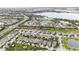 Wide aerial view of the community, highlighting proximity to a lake and amenities at 4911 Drawdy Ct, St Cloud, FL 34772