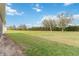 View of the backyard featuring a well-manicured lawn and several trees at 4911 Drawdy Ct, St Cloud, FL 34772