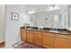 Double sink bathroom vanity with granite countertops, wood cabinets, and a large mirror at 4911 Drawdy Ct, St Cloud, FL 34772