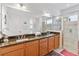 Bright bathroom with a double sink vanity, granite countertops, and glass enclosed shower at 4911 Drawdy Ct, St Cloud, FL 34772