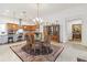 Elegant dining room featuring a glass table, chandelier, and access to the open kitchen at 4911 Drawdy Ct, St Cloud, FL 34772