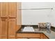 Laundry sink featuring granite countertops and wooden cabinetry at 4911 Drawdy Ct, St Cloud, FL 34772