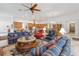 Open-concept living room with large center table, ceiling fan, and modern lighting at 4911 Drawdy Ct, St Cloud, FL 34772