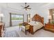 Spacious main bedroom with a tray ceiling, large window, and elegant furnishings at 4911 Drawdy Ct, St Cloud, FL 34772