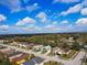 An aerial view of the residential neighborhood, highlighting the surrounding landscape and proximity to trees at 4941 Luna Negra Dr, Orlando, FL 32811