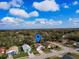 Aerial shot pinpointing a cozy home with a driveway and surrounded by lush trees and greenery at 4941 Luna Negra Dr, Orlando, FL 32811