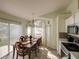 Charming dining area featuring natural light, a chandelier, and an open concept design at 4941 Luna Negra Dr, Orlando, FL 32811