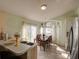 Bright dining area with large window, chandelier, and connection to the kitchen, perfect for Gathering meals at 4941 Luna Negra Dr, Orlando, FL 32811