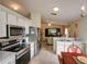 Modern kitchen featuring stainless steel appliances and an open layout leading to the living room at 4941 Luna Negra Dr, Orlando, FL 32811