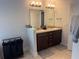 Bright bathroom featuring double vanity with granite countertops at 499 Meadow Pointe Dr, Haines City, FL 33844