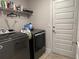 Functional laundry room with modern washer and dryer, plus practical shelving at 499 Meadow Pointe Dr, Haines City, FL 33844