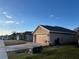 Street view of single-Gathering homes each with paved driveways and attached garages at 499 Meadow Pointe Dr, Haines City, FL 33844