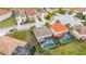 Aerial view of homes with tile roofs and screened pools in a neatly planned community at 5411 Oakgrain Ct, Davenport, FL 33837