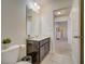 Well-lit bathroom features modern fixtures, a sleek vanity, and easy access to the hallway and bedroom at 5411 Oakgrain Ct, Davenport, FL 33837