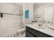 Bathroom featuring a shower-tub combo, vanity with dark cabinets, and flamingo wall art at 5411 Oakgrain Ct, Davenport, FL 33837