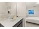 Bathroom with sink and vanity, medicine cabinet and view to the bedroom at 5411 Oakgrain Ct, Davenport, FL 33837