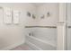 Bathtub featuring a tile backsplash and a wall-mounted shower head and faucet at 5411 Oakgrain Ct, Davenport, FL 33837