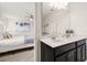 Bathroom featuring a double vanity and a view into the main bedroom at 5411 Oakgrain Ct, Davenport, FL 33837