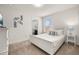 Bedroom with white furniture, a bed with pillows, and decorative wall art at 5411 Oakgrain Ct, Davenport, FL 33837