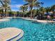 Stunning community pool offering island seating, inviting lounges, umbrellas, and a view of the slide at 5411 Oakgrain Ct, Davenport, FL 33837