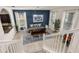 Dining room featuring a modern chandelier, lots of light, and a blue accent wall at 5411 Oakgrain Ct, Davenport, FL 33837