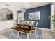 Stylish dining room features a modern light fixture and bold accent wall at 5411 Oakgrain Ct, Davenport, FL 33837