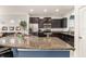 Modern kitchen boasts a curved breakfast bar with granite countertops and stainless steel appliances at 5411 Oakgrain Ct, Davenport, FL 33837