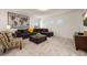 Cozy living room with plush seating, neutral carpet, and a striking world map art piece on the wall at 5411 Oakgrain Ct, Davenport, FL 33837