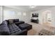 This living room boasts a large sectional sofa, ottoman, TV, and neutral carpeting, creating a comfortable and inviting atmosphere at 5411 Oakgrain Ct, Davenport, FL 33837