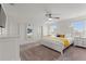 Spacious main bedroom with a ceiling fan, carpet flooring, and two windows for natural light at 5411 Oakgrain Ct, Davenport, FL 33837