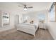 Main bedroom features a ceiling fan, neutral colored walls, and a large window at 5411 Oakgrain Ct, Davenport, FL 33837