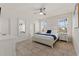 Bright main bedroom with a serene color palette, tiled flooring, and ample natural light at 5411 Oakgrain Ct, Davenport, FL 33837