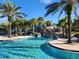 Inviting pool area boasting a waterslide, surrounded by palm trees, and ample space for relaxation at 5411 Oakgrain Ct, Davenport, FL 33837