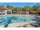 Zero-entry pool features shade umbrellas and shallow water for the enjoyment of residents and guests at 5411 Oakgrain Ct, Davenport, FL 33837