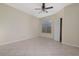 Light-filled bedroom with neutral paint, ceiling fan, tiled floor, window, and closet at 5578 Metrowest Blvd # 11, Orlando, FL 32811