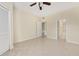 Bright main bedroom with ceiling fan, tile floors, and doorways to the ensuite bathroom and walk-in closet at 5578 Metrowest Blvd # 11, Orlando, FL 32811