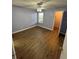 Bedroom with wood floors and a ceiling fan at 5587 Devonbriar Way # 106, Orlando, FL 32822