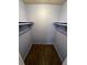 This closet offers ample storage space with shelving and hardwood floors at 5587 Devonbriar Way # 106, Orlando, FL 32822