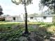 View of a home's backyard featuring the lawn and trees at 5804 Viking Rd, Orlando, FL 32808