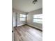 Bright room with wood-look flooring and natural light from two windows at 5804 Viking Rd, Orlando, FL 32808