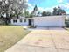 Well-maintained home featuring an attached two-car garage and manicured front lawn at 5804 Viking Rd, Orlando, FL 32808