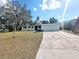 Inviting single-story home with mature trees, lawn, and concrete driveway at 5804 Viking Rd, Orlando, FL 32808