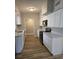 A bright kitchen featuring stainless steel appliances, white countertops, and white cabinets at 5804 Viking Rd, Orlando, FL 32808