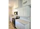 A well-lit kitchen featuring stainless steel appliances, white countertops, and white cabinets at 5804 Viking Rd, Orlando, FL 32808